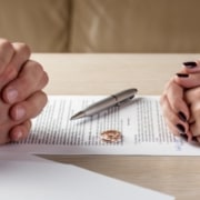 LPEP Law helps a couple with the divorce question of dividing property after a divorce. Two rings on the table between the clients.