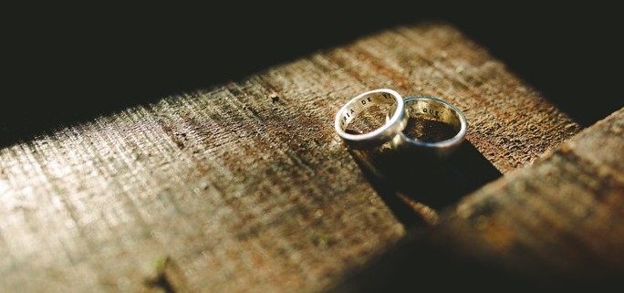Two rings sit on a table after a couple went through rigorous divorce planning