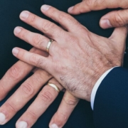 A partner rests their hand on top of their fiance's hand as they discuss a prenup agreement