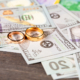 High Net Worth Divorce Wedding Rings Atop Dollar Bills