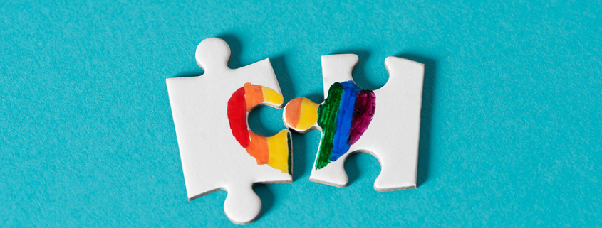 Two Puzzle Pieces Torn Apart breaking apart with rainbow heart split. same-sex divorce