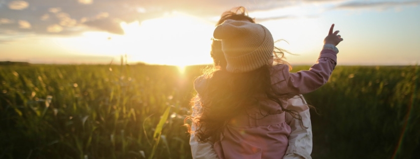Woman in Field With Daughter at sunset, importance of estate planning