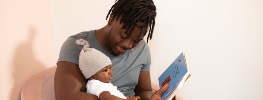 Biological father reads son a book