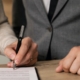 Man signing a postnuptial agreement with attorney