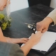 Man & woman at table signing documents, Signing a postnuptial agreement