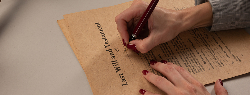 Woman signing papers, last will at the office. Is a will the same thing as an estate plan?