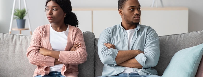 Disappointed couple with arms crossed on chest having relationships crisis, sitting on couch and looking aside, do not talking to each other after fight. Legal Separation agreement.
