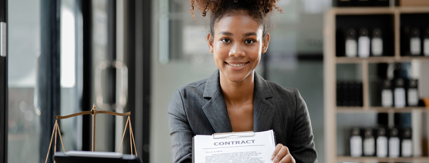 American lawyer sits in a law firm, female lawyer holding a contract document. Power of attorney in property management