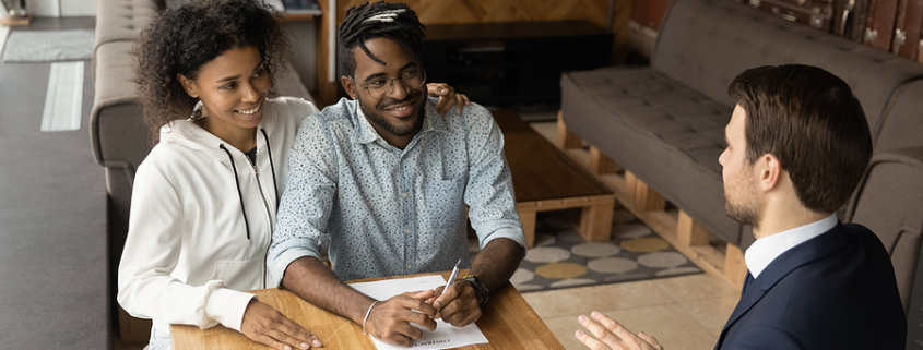Happy young african american family couple talking with professional lawyer. importance