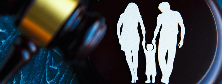Cutout family and colourful letters regarding child-custody and family-law.
