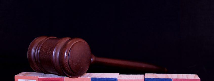 Baby blocks spelling out the word custody with a gavel on top highlighting a material change in custody.