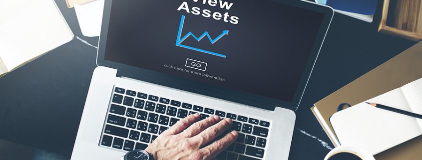 Person using laptop with digital icons representing assets, symbolizing online Estate Planning and managing digital will.