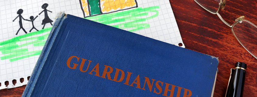 A book titled "Guardianships and Children" placed next to a drawing of a child, symbolizing the importance of choosing a legal guardian.