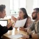Couple arguing with a realtor over estate disputes and legal issues regarding property or inheritance.