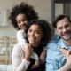 Happy multiracial couple enjoying time with their children, representing the love and unity found in blended families.