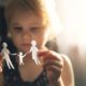 Little girl holding paper family cutout, symbolizing divorce and custody issues when mediation fails.