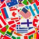 Top view of a heap of national flags from various countries, symbolizing global family dynamics and cross-border connections.”