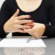 Woman removing wedding ring from her hand, symbolizing annulment and the end of a marriage.