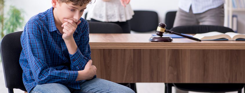 Divorcing parents discussing child custody agreements with their young child during separation.