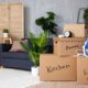 Stacked moving boxes in a living room after relocating to a new State, symbolizing transition and estate planning updates.
