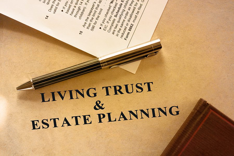 Estate planning document labeled “Living Trust” on a desk, symbolizing legal protection and planning for unmarried couples in California.