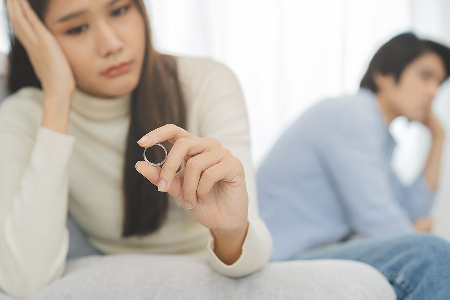 Stressed couple arguing on a couch, symbolizing relationship conflict and the emotional challenges that may lead to an annulment decision.