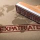 Expatriate Estate Planning concept showing a world map with the word “expatriate” and a rubber stamp, representing international legal and financial planning.