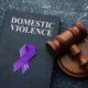 Melanie’s Law concept with judge gavel and domestic violence legal document on grey table symbolizing protection and legal reform