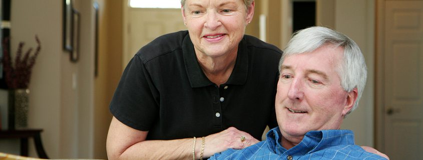 Retired couple planning finances and reviewing pension pots for estate and retirement planning.