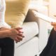 Mental health consultation between a psychiatrist and a stressed female patient during a counseling session, discussing emotional well-being and mental health concerns in a clinical setting.