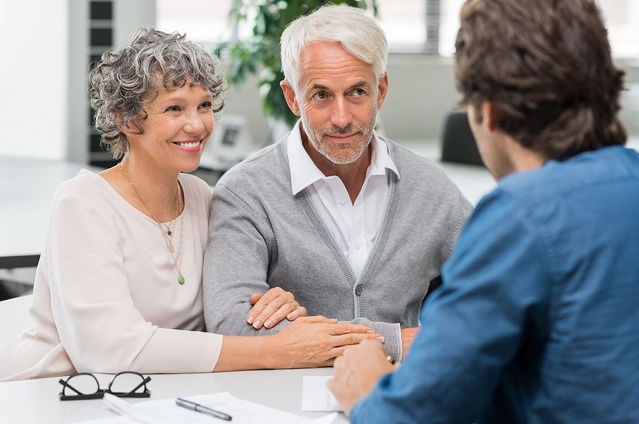Senior couple meeting a financial advisor to discuss retirement investment plans for child-free retirees