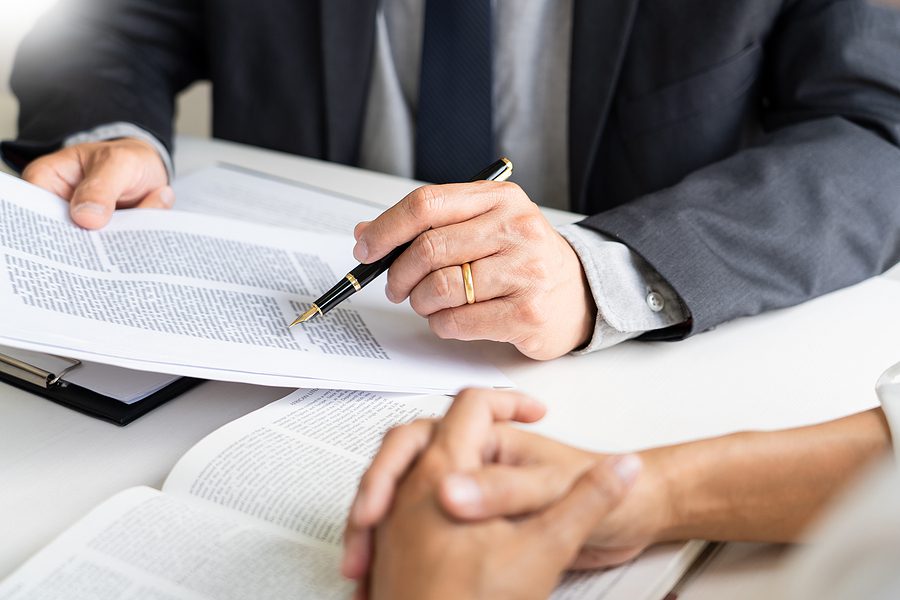 Lawyers discussing estate planning documents and whether legal fees are Tax Deductible.