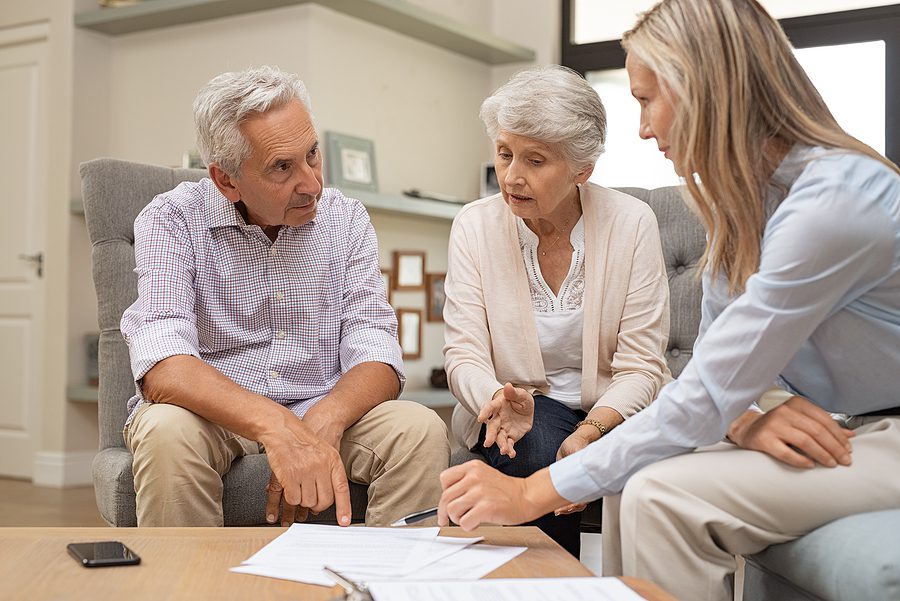 Financial advisor reviewing an estate plan with a retired couple.