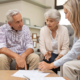 Federal retirement laws discussed as an advisor points to contract terms while planning with a retired couple